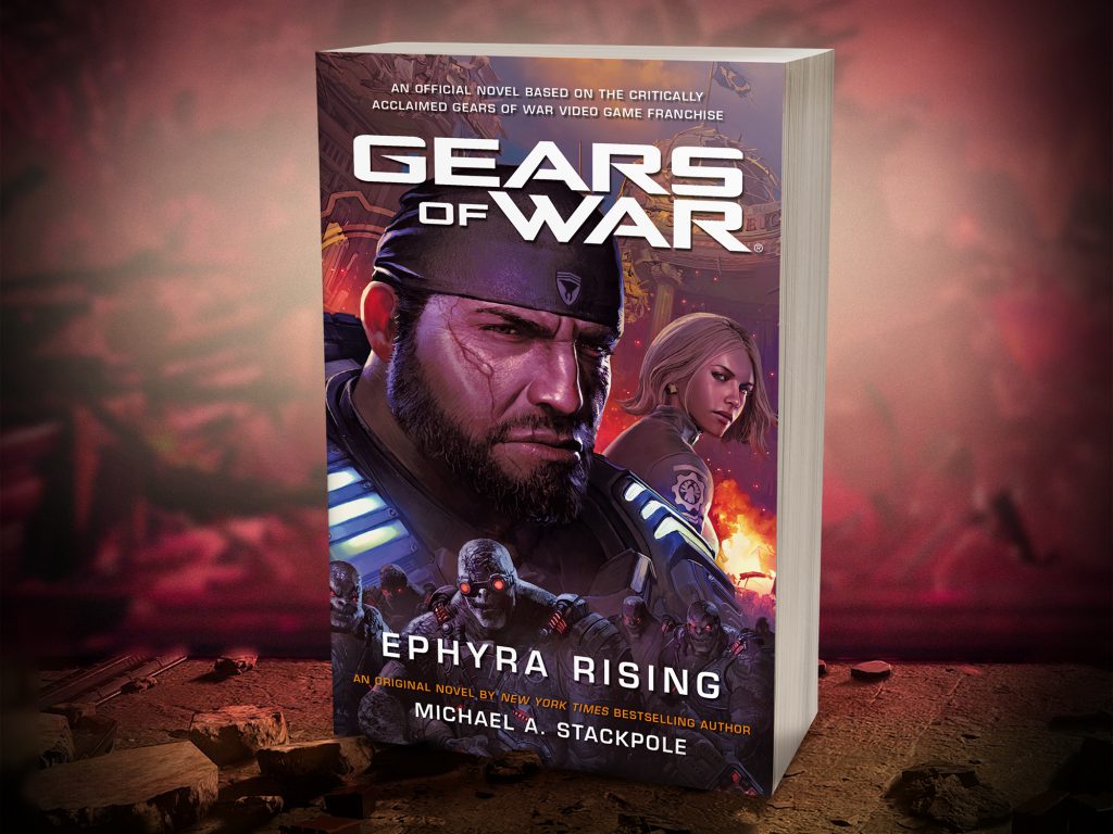 The Gears of War: Ephyra Rising physical novel showcased on a piece of rubble with wreckage behind it